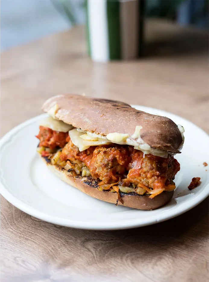 Meatball sandwich in tomato sauce with melted cheese